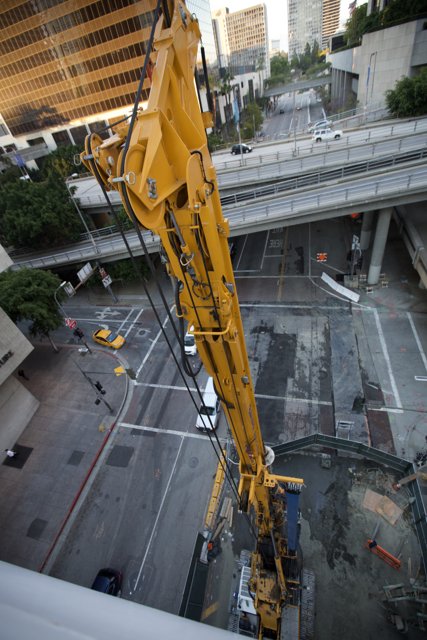 Yellow Construction Crane Sitting on Building