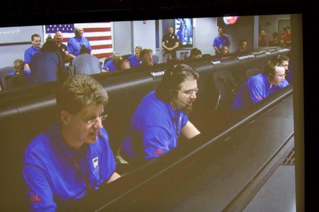 Blue Shirted Men Working on Computer
