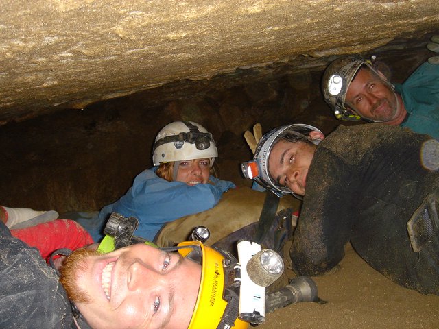 Cavers Squeeze Through Tight Underground Passage Together