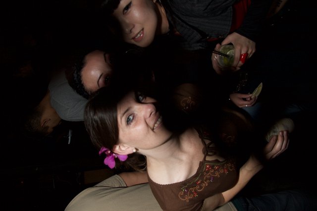 Friends Leaning In at a Nightclub Art Walk