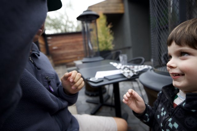 Two Children Holding Hands at Outdoor Patio