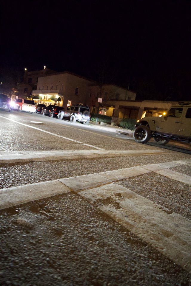 Nighttime Jeep Gathering on Wet Street