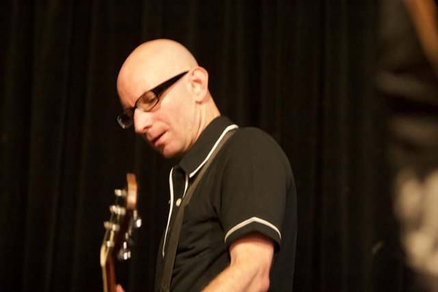 Bald Man with Glasses Shreds on Guitar