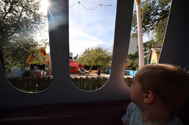 Child's Wonder: Peering Through Playground Windows