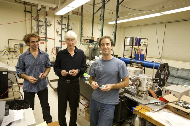 Three Men at Work in High-Tech Laboratory