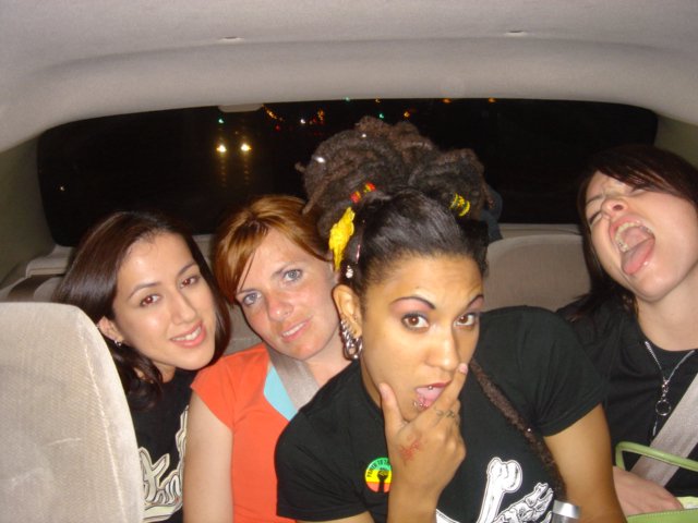 Four Friends Laughing Together in a Vehicle at Night