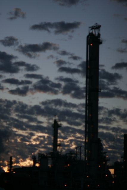 Towering Refinery Under Dark Skies