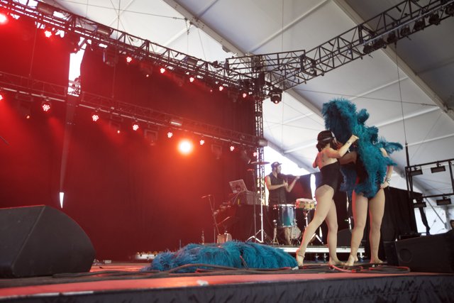 Blue Feathered Performers on Stage
