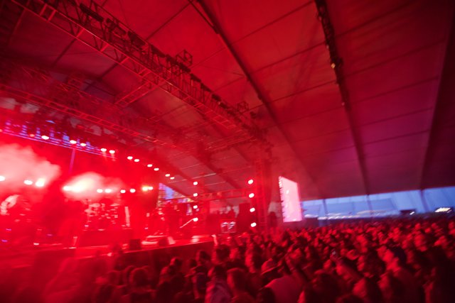 Red Spotlight on A Rock Concert Crowd