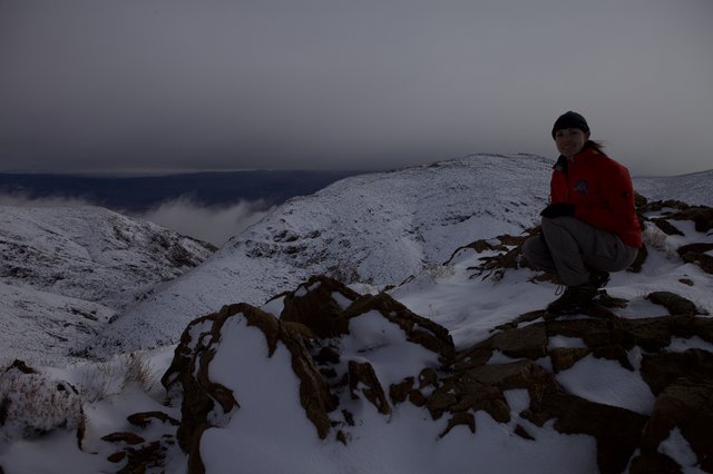 Winter Summit Rest on Snow-Covered Mountain Ridge