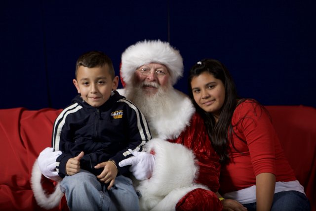 Santa Claus Spreading Holiday Cheer with Two Children