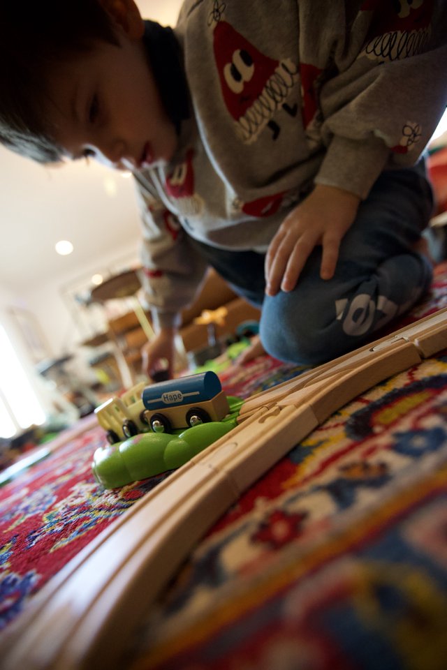 Child Playing with Wooden Train Set on Christmas Day