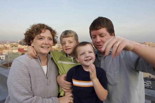 Family Rooftop Portrait at City Sunset