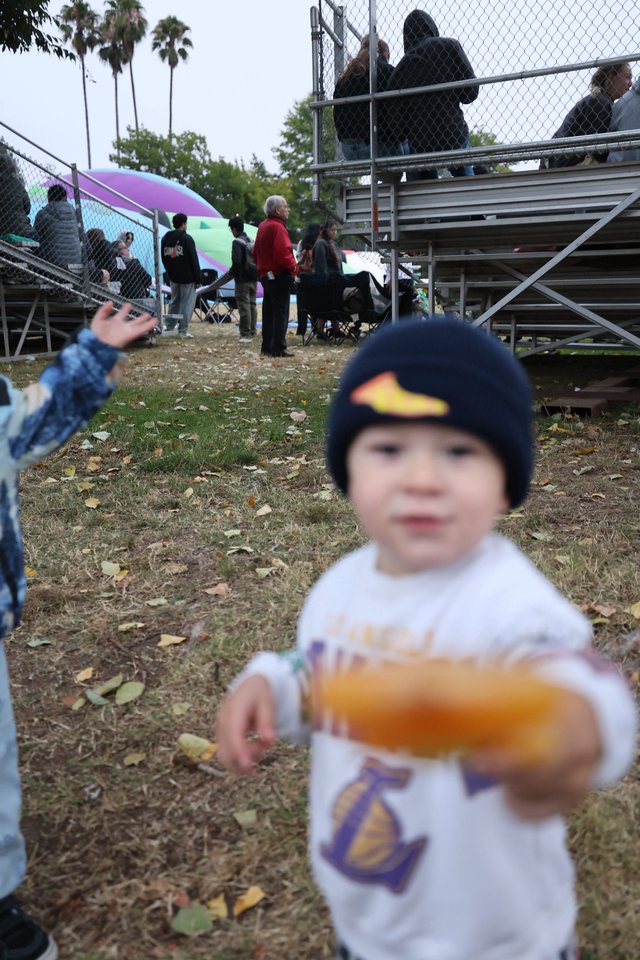 Toddler Offers Snack at Hot Air Balloon Festival