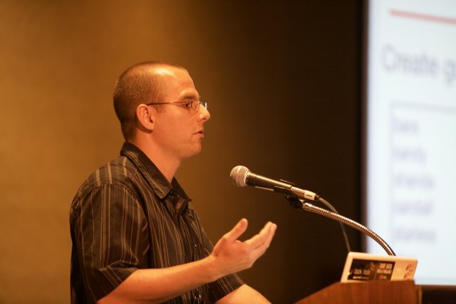 A Man Giving an Engaging Presentation to a Massive Crowd