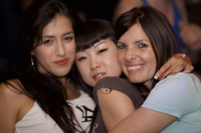 Three Friends Embrace at a Nightclub in 2006