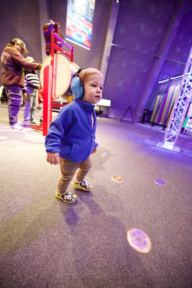 Young Child Exploring Interactive Museum Sound Exhibit