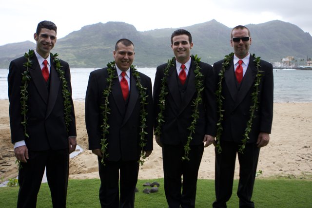 Four Men in Formal Wear Pose on Hawaii's Cloudy Shore