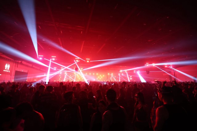 Massive Crowd Ignites Under Red Light Storm