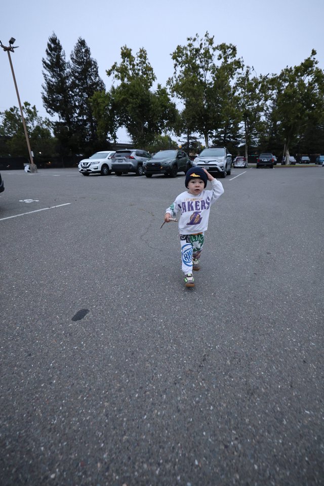 Toddler Runs Free in Parking Lot at Balloon Festival