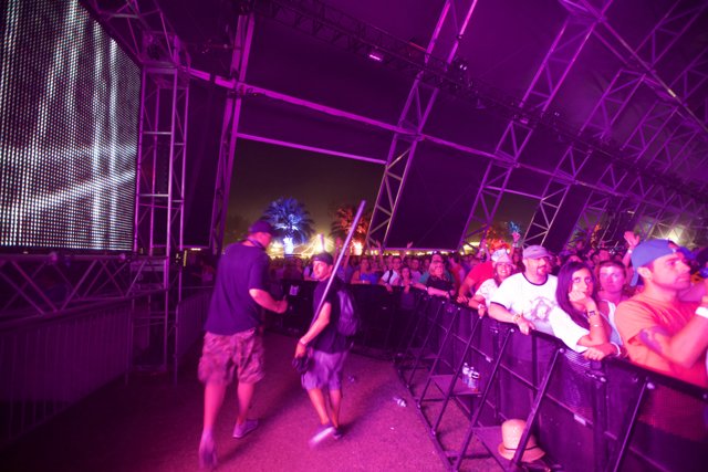 Partygoers Enjoying a Concert at Coachella with Large Screen