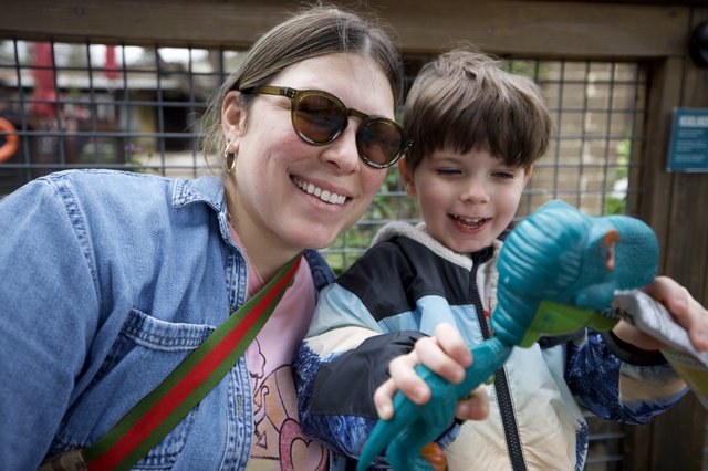 Joyful Mother and Son with Toy Dinosaurs