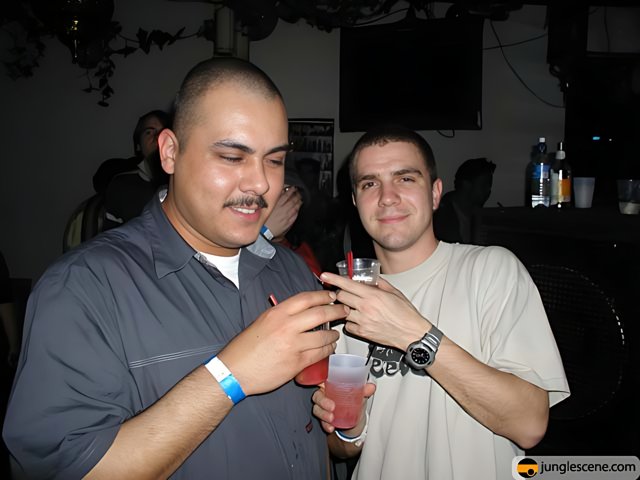 Two Men Enjoying Drinks at Nightclub