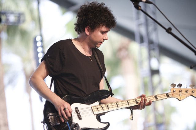 Curly-haired Bassist on Stage
