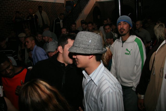 Man in a Stylish Beanie Hat in a Busy Bar