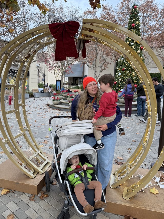Family Holiday Moment Through Festive Golden Archway