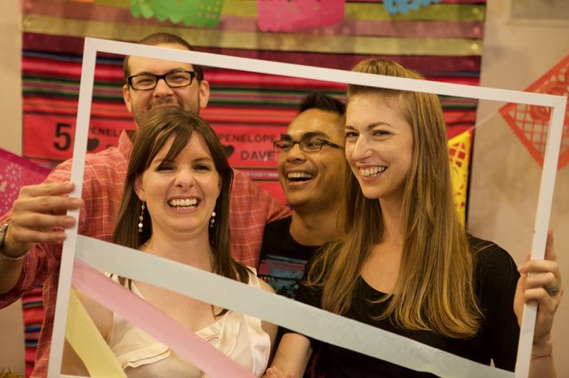 Friends Laugh Through a Giant Photo Frame