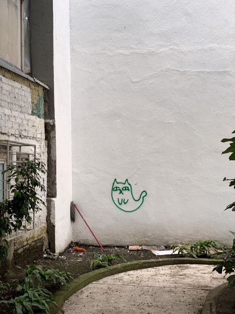 Green Cat Mural Adorns Courtyard Wall