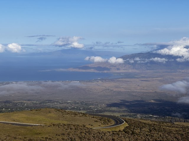 Aerial View of Maui's Scenic Road with Majestic Mountain Ranges