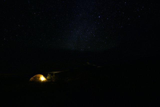 Illuminated Tent in the Starry Night Sky