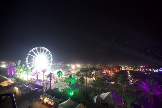 Illuminated Fun: Ferris Wheel and Lights at Night