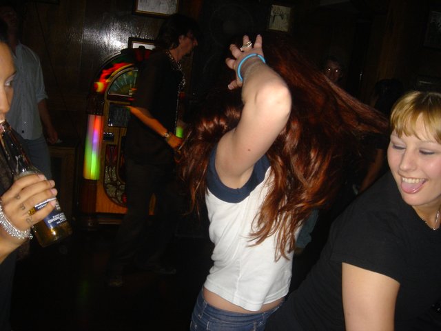 Red-Haired Beauty Enjoys Nightlife with Friends
