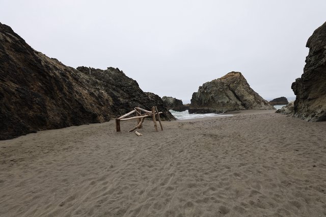 Secluded Coastal Cove with Driftwood Structure