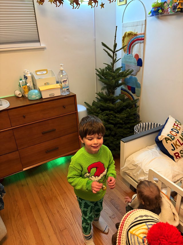 Siblings Decorating Christmas Tree in Cozy Bedroom