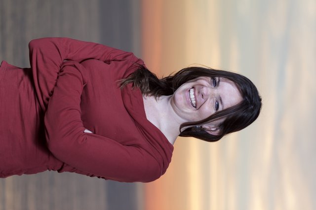 Joyful Woman Laughing at Sunset by the Sea