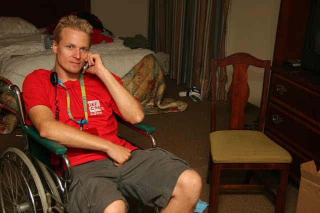 Wheelchair-bound man in his bedroom