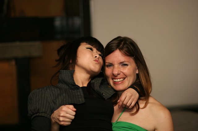 Two Friends Laugh and Pose at a Party