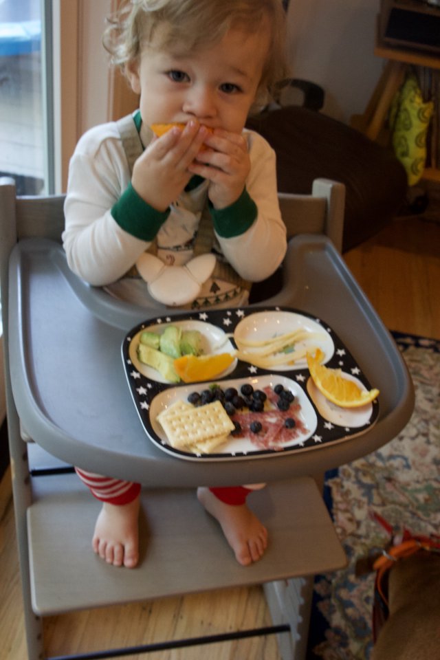 Toddler Enjoying Healthy Snack Time in High Chair