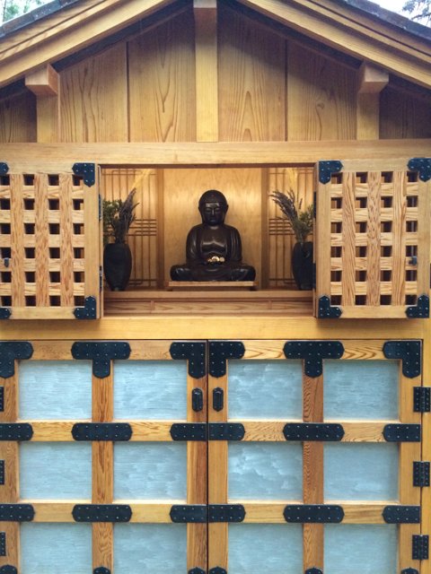 Buddha Statue Sitting on Wooden Door