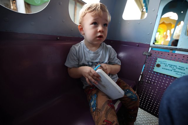 Toddler with Milk Box at Indoor Play Area