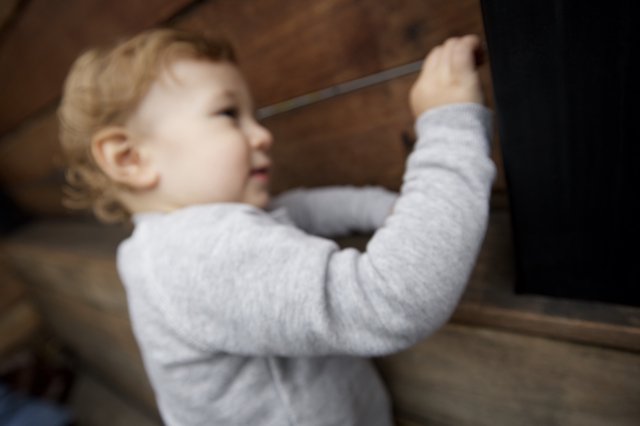 Toddler Reaching Up Indoor Wooden Staircase