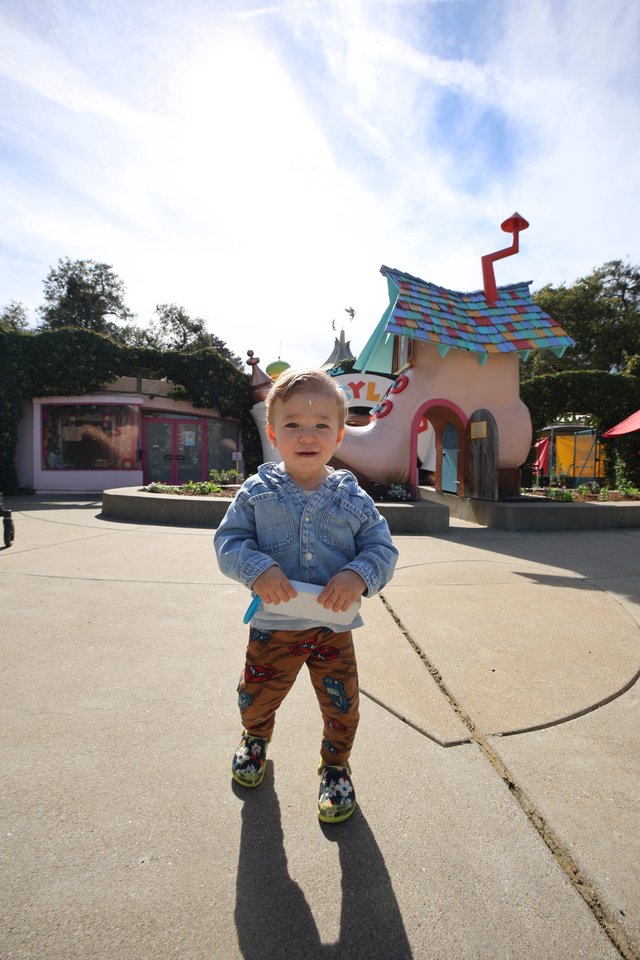 Joyful Toddler at Whimsical Shoe House Attraction