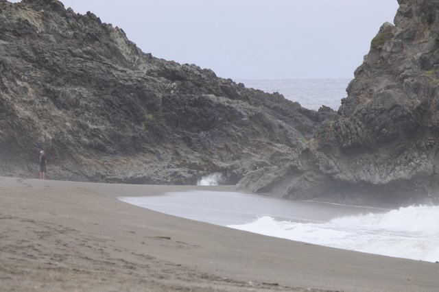 Solitary Figure at Misty Rocky Cove Beach