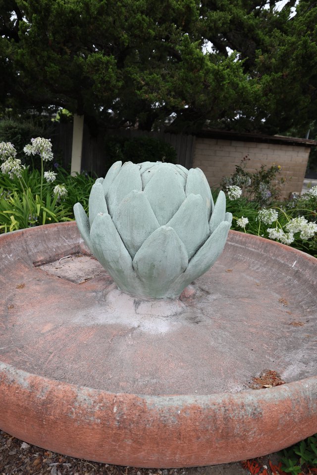Artichoke Fountain Sculpture in Serene Garden Setting