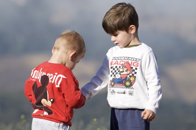 Two Young Brothers Share a Quiet Outdoor Moment