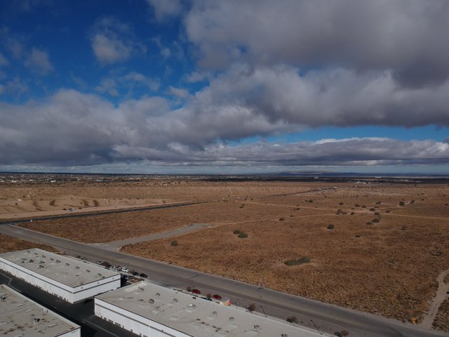 Desert Highway under Cumulus Clouds